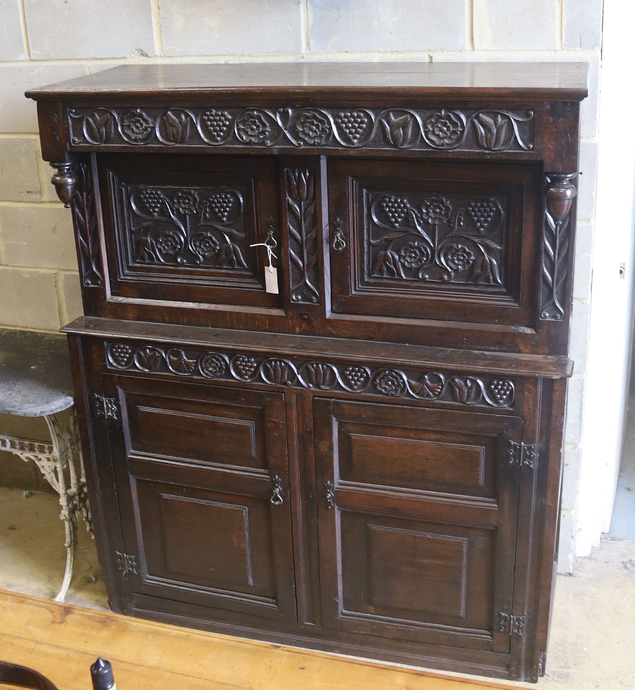 An 18th century carved oak court cupboard, length 134cm, depth 50cm, height 158cm